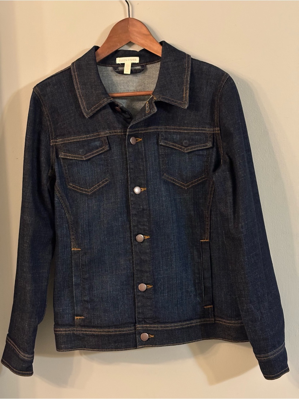 Eileen Fisher dark wash slightly distressed denim jacket. Long sleeves.
